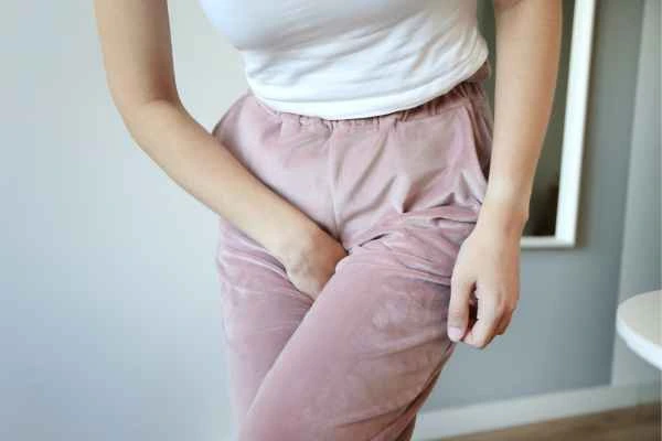 older woman running to the toilet because of urinary incontinence Bridgend